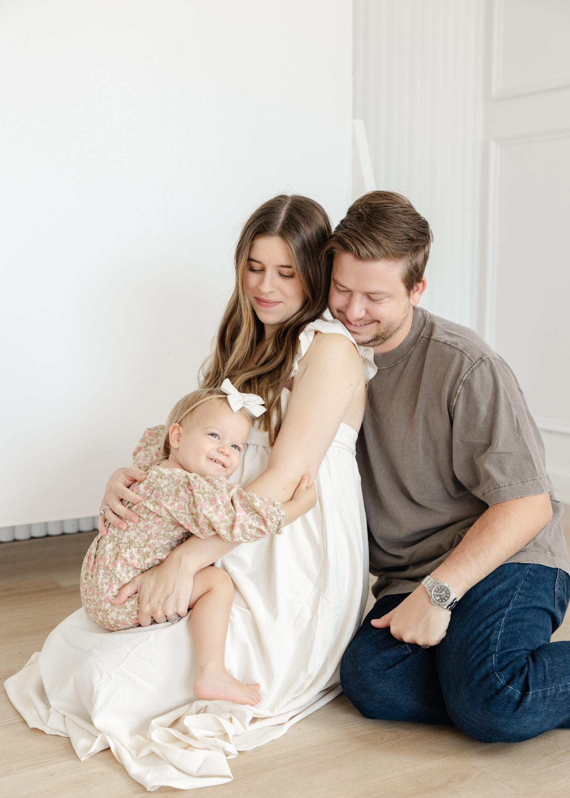 family of 3 snuggling to celebrate new daughter's arrival, Edmond maternity photography