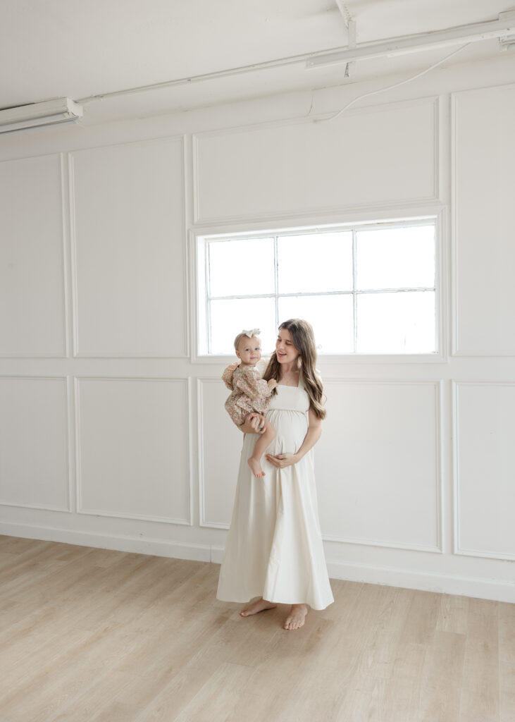 Mom dancing with her toddler before welcoming a new baby! oklahoma maternity studio photographer